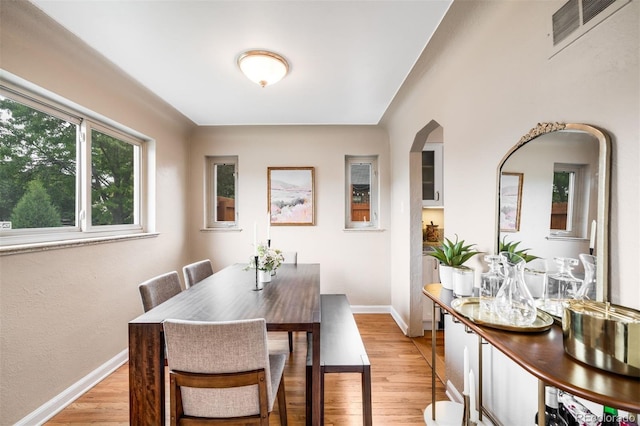2255 Perry St, Denver, CO 80212 - dining space with light wood finished floors, baseboards, and arched walkways