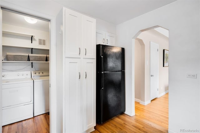 2255 Perry St, Denver, CO 80212 - laundry area featuring arched walkways, light wood-style flooring, independent washer and dryer, and baseboards