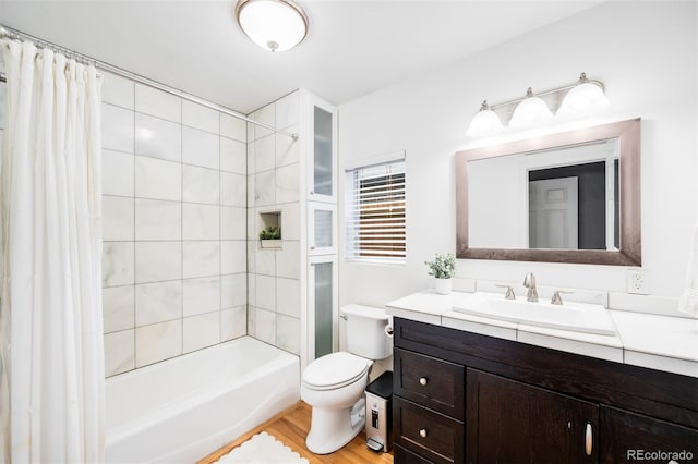2255 Perry St, Denver, CO 80212 - bathroom featuring vanity, toilet, shower / tub combo with curtain, and wood finished floors