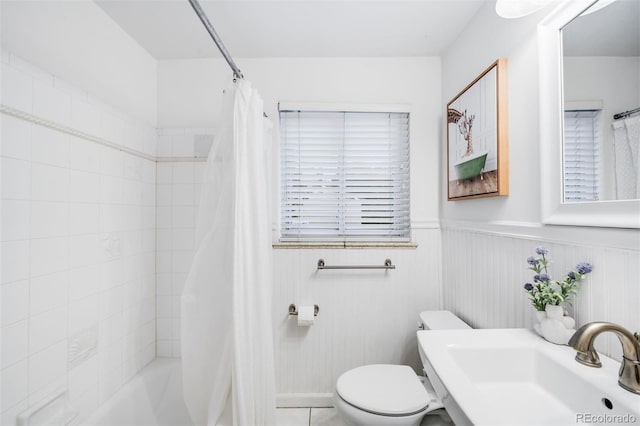 2255 Perry St, Denver, CO 80212 - bathroom featuring toilet, a sink, shower / bath combination with curtain, and a wainscoted wall