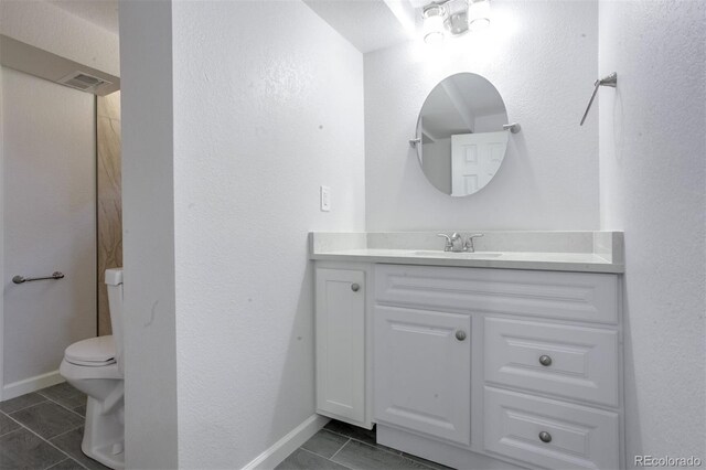 bathroom with visible vents, toilet, vanity, and baseboards