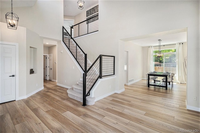 17174 E Rosebay Cir, Parker, CO 80134 - foyer featuring a chandelier, light wood-style floors, stairs, and a towering ceiling