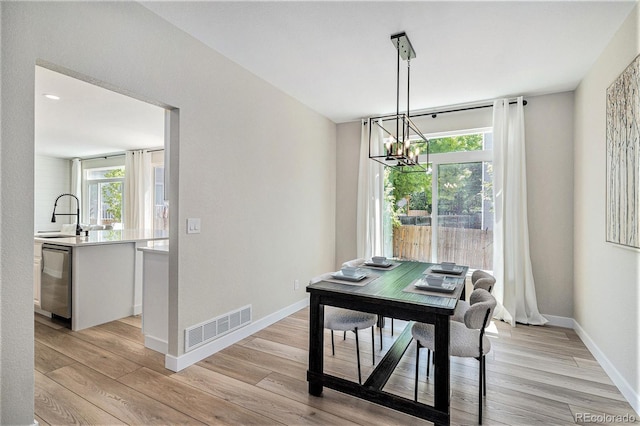 17174 E Rosebay Cir, Parker, CO 80134 - dining area with light wood finished floors and a chandelier