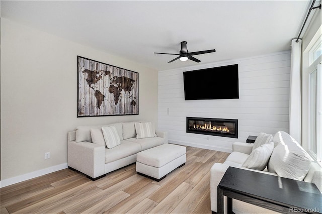 17174 E Rosebay Cir, Parker, CO 80134 - living room featuring light wood finished floors, a ceiling fan, and a fireplace