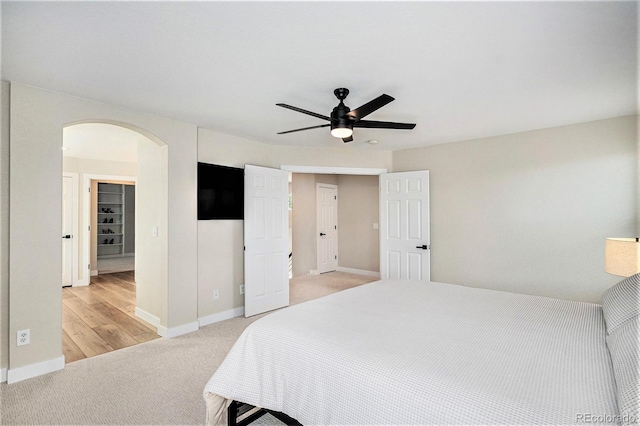 17174 E Rosebay Cir, Parker, CO 80134 - bedroom with arched walkways, light carpet, and a ceiling fan