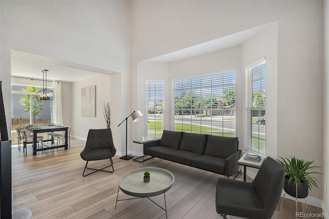 17174 E Rosebay Cir, Parker, CO 80134 - living room with a chandelier, healthy amount of natural light, and light wood-type flooring