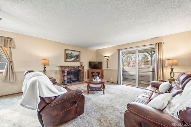 living room featuring a fireplace with raised hearth, a textured ceiling, and carpet
