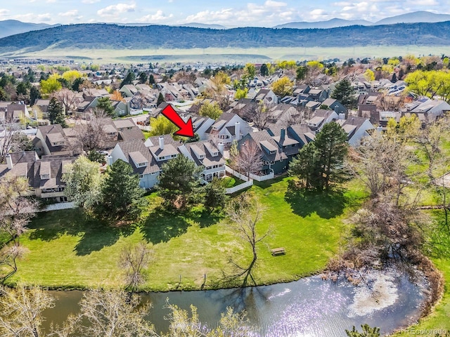 drone / aerial view with a residential view and a water and mountain view