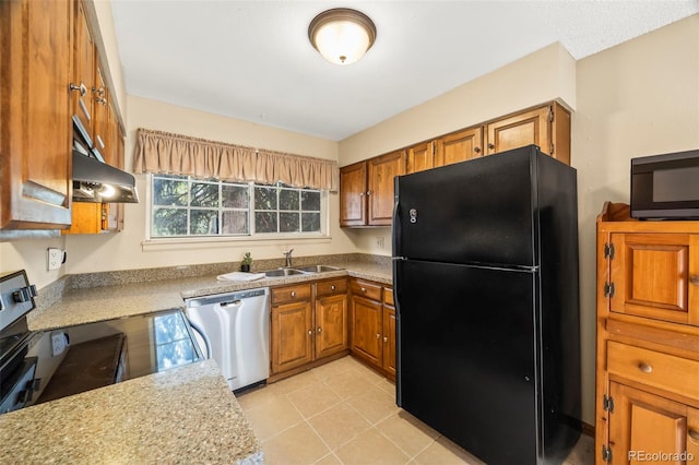 kitchen featuring light countertops, under cabinet range hood, brown cabinets, a sink, and black appliances