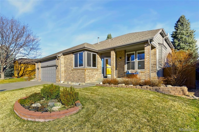 ranch-style house featuring a front lawn, roof with shingles, concrete driveway, an attached garage, and brick siding