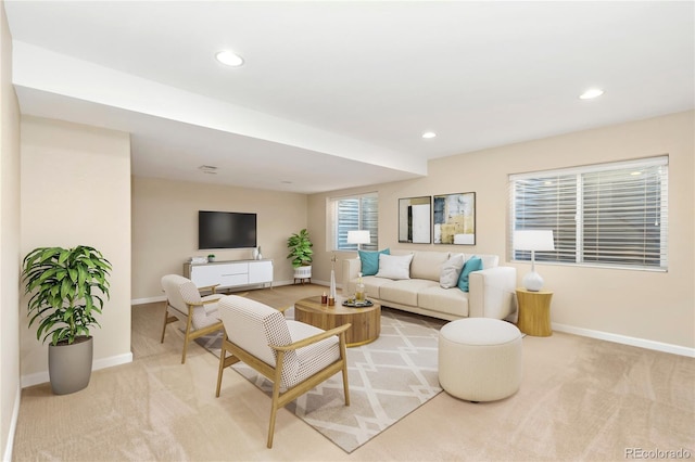 living area with recessed lighting, light colored carpet, and baseboards