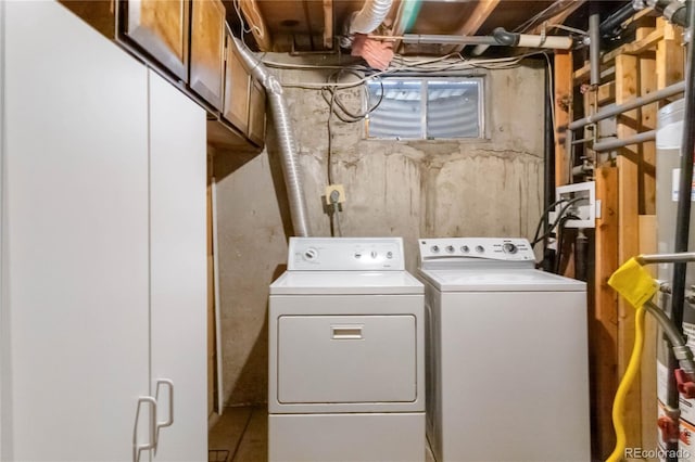 clothes washing area featuring laundry area and washer and clothes dryer