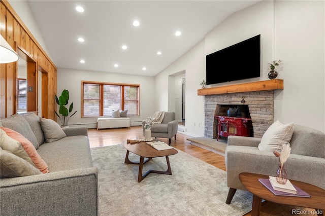 2020 Routt St, Lakewood, CO 80215 - living room with vaulted ceiling, recessed lighting, light wood-style flooring, and a wood stove