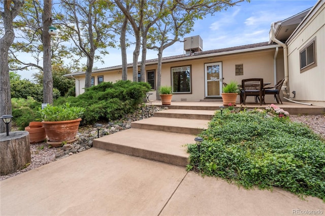 2020 Routt St, Lakewood, CO 80215 - view of exterior entry featuring a patio and stucco siding