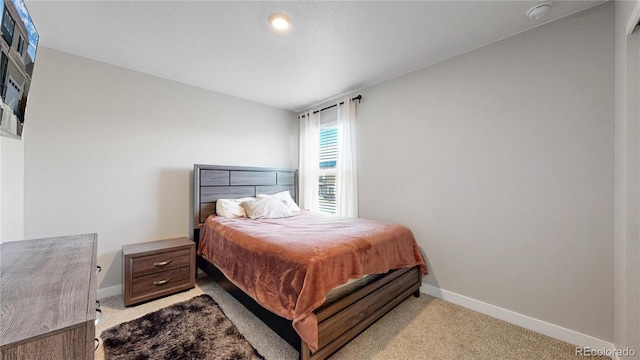 carpeted bedroom featuring baseboards