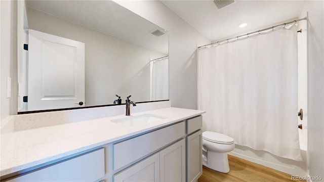 17947 E 95th Ave, Commerce City, CO 80022 - bathroom with vanity, wood finished floors, toilet, and shower / bathtub combination with curtain