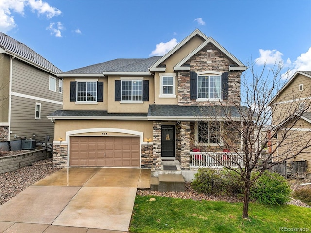 craftsman house featuring stone siding, stucco siding, cooling unit, and an attached garage