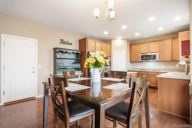 dining room with wood finished floors, recessed lighting, and a chandelier