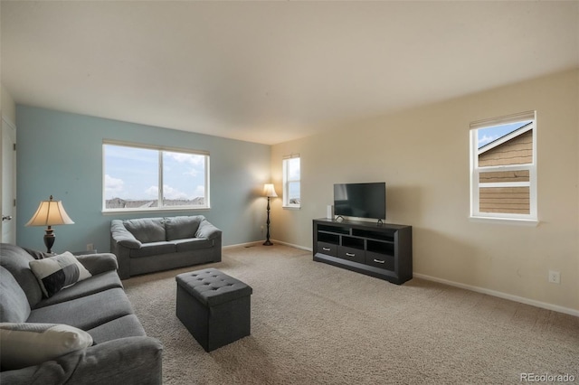 carpeted living room with baseboards