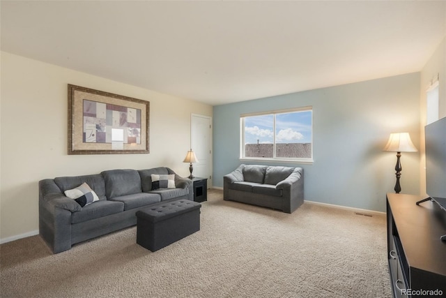living area featuring light carpet and baseboards