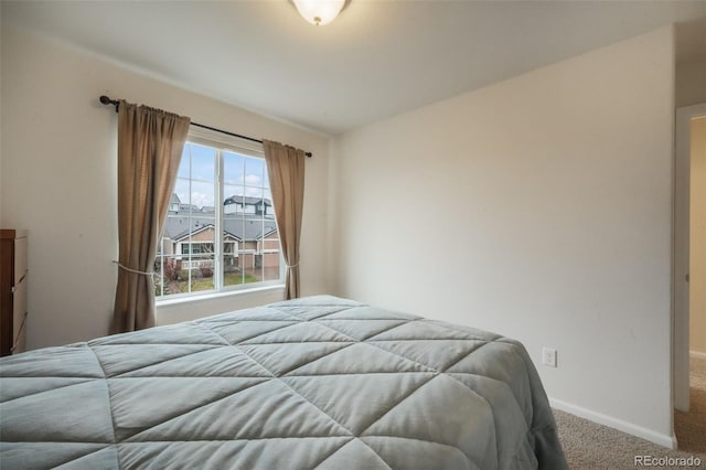 carpeted bedroom with baseboards