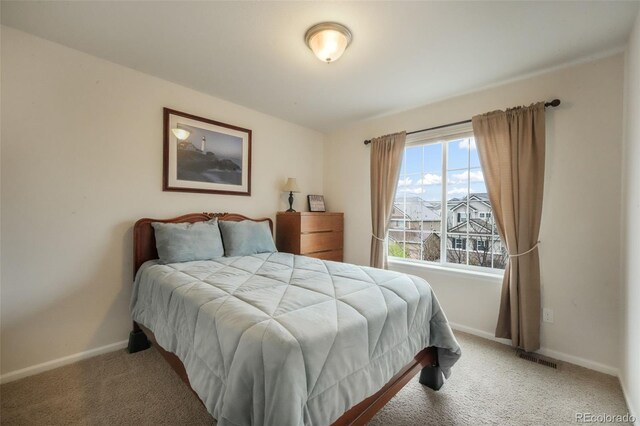 bedroom with carpet and baseboards