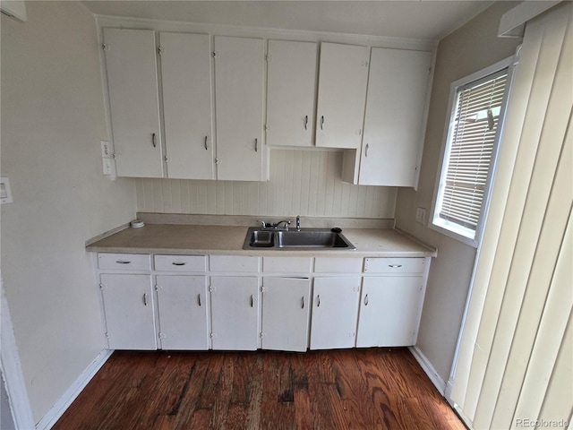 1717 Oswego St, Aurora, CO 80010 - kitchen featuring a sink, baseboards, light countertops, and dark wood-type flooring