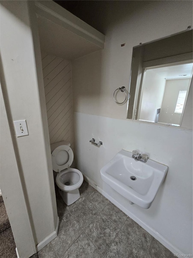 1717 Oswego St, Aurora, CO 80010 - bathroom with toilet, tile patterned flooring, and baseboards