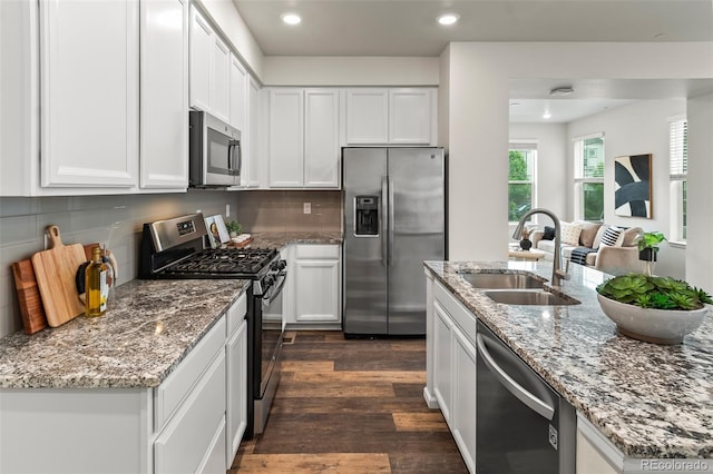 315 Zeppelin Way, Fort Collins, CO 80524 - kitchen with appliances with stainless steel finishes, a sink, white cabinetry, dark wood-type flooring, and recessed lighting
