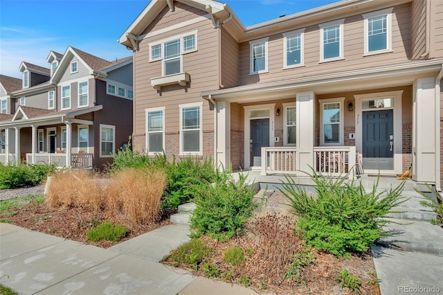 315 Zeppelin Way, Fort Collins, CO 80524 - view of property with covered porch and brick siding