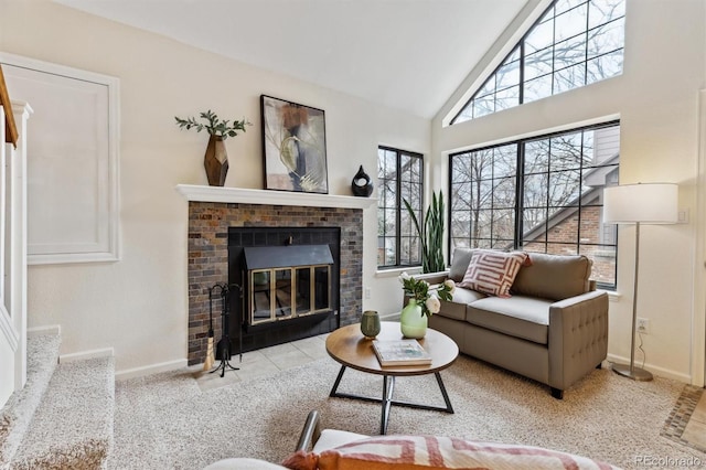 carpeted living room with baseboards, high vaulted ceiling, and a brick fireplace