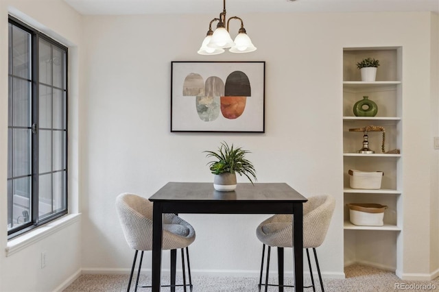 dining room featuring baseboards, a notable chandelier, carpet, and a wealth of natural light
