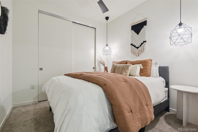 carpeted bedroom featuring a closet and ceiling fan