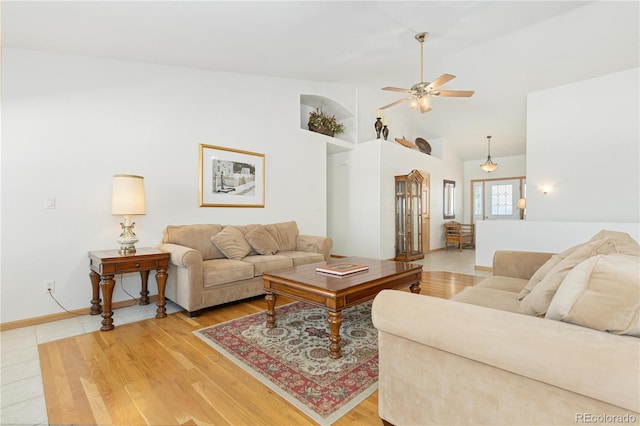 living room with wood-type flooring, high vaulted ceiling, and ceiling fan