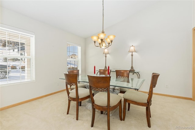 carpeted dining space featuring an inviting chandelier and vaulted ceiling