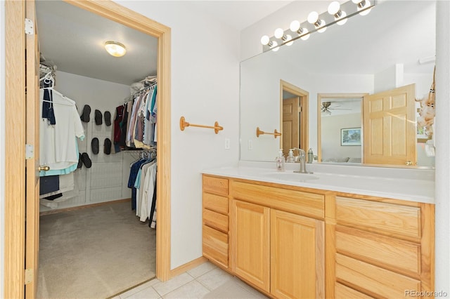 bathroom featuring tile patterned flooring, ceiling fan, and vanity