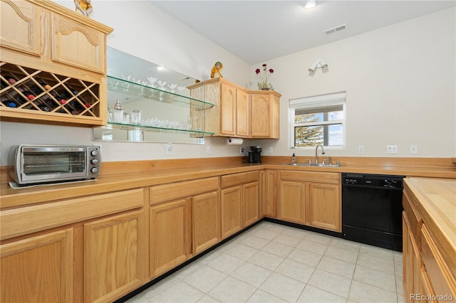 kitchen with sink, dishwasher, and butcher block countertops