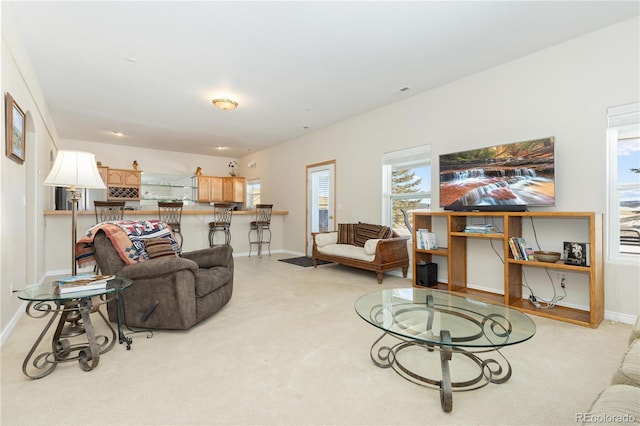 living room featuring a healthy amount of sunlight and light colored carpet