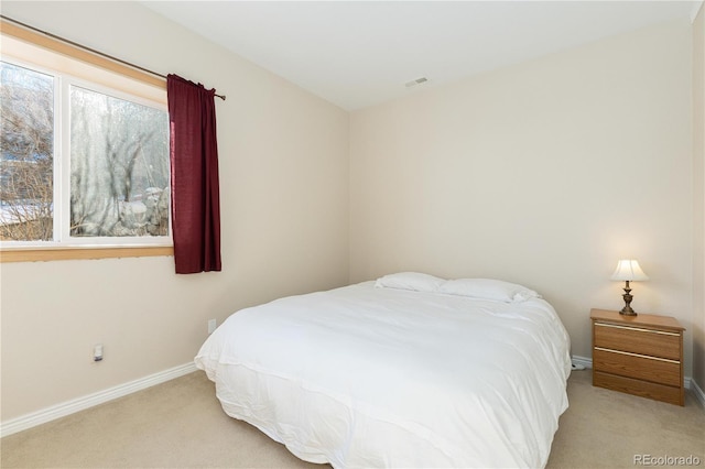 bedroom featuring light colored carpet