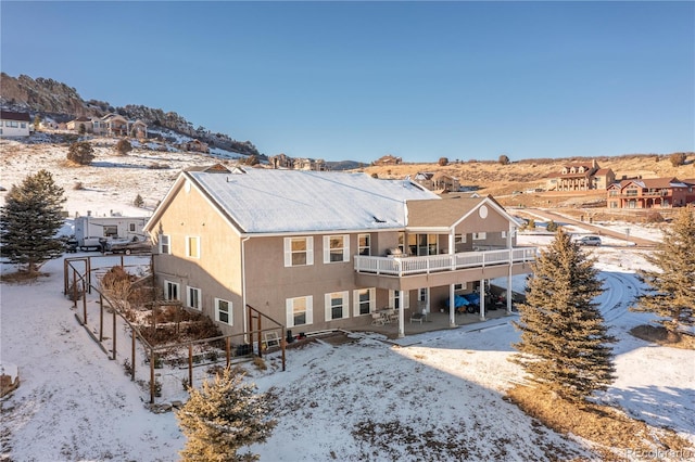 snow covered property featuring a balcony