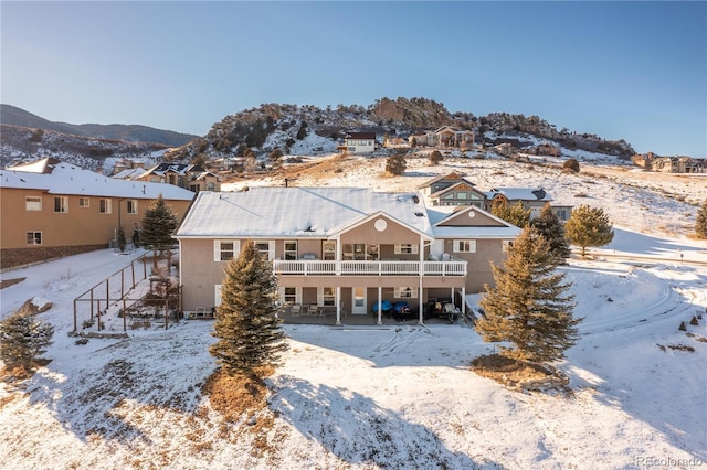 snow covered property featuring a mountain view