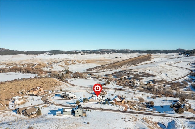 snowy aerial view featuring a mountain view