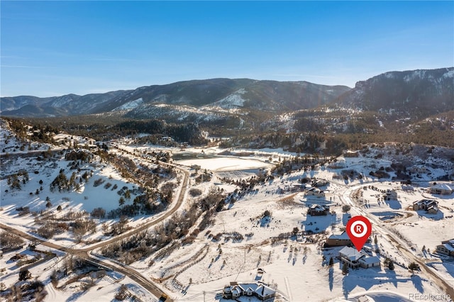 snowy aerial view featuring a mountain view