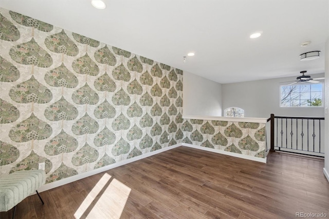 spare room with recessed lighting, baseboards, wallpapered walls, and wood finished floors