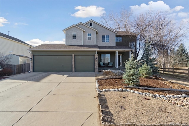 view of front of home with concrete driveway, roof with shingles, an attached garage, a porch, and fence
