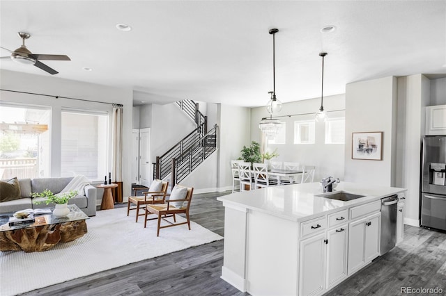 6037 N Netherland Ct, Aurora, CO 80019 - kitchen featuring appliances with stainless steel finishes, a sink, healthy amount of natural light, dark wood-style floors, and recessed lighting