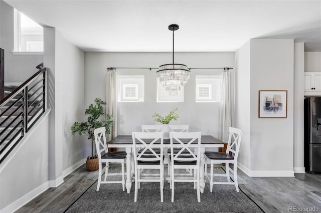 6037 N Netherland Ct, Aurora, CO 80019 - dining room featuring a chandelier, wood finished floors, and baseboards