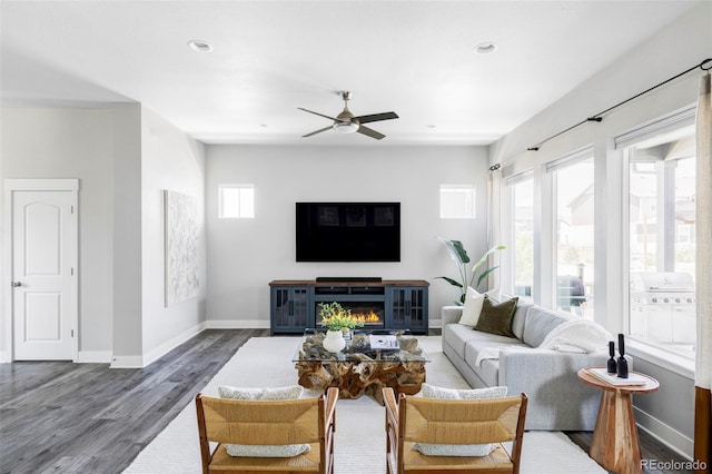 6037 N Netherland Ct, Aurora, CO 80019 - living room featuring wood finished floors, ceiling fan, baseboards, recessed lighting, and a glass covered fireplace