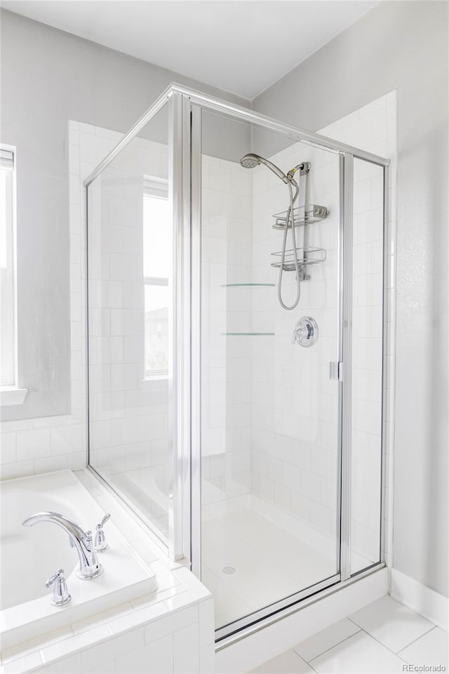 6037 N Netherland Ct, Aurora, CO 80019 - full bath with a stall shower, a garden tub, and tile patterned flooring