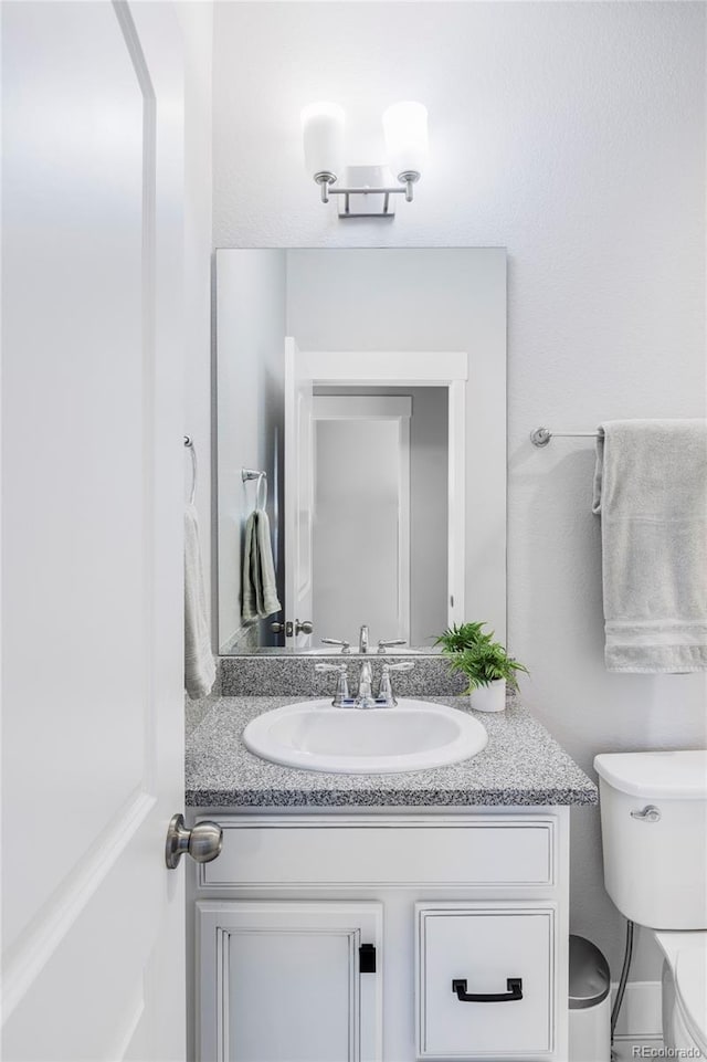 6037 N Netherland Ct, Aurora, CO 80019 - bathroom with vanity and toilet